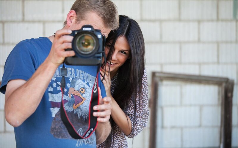 Man taking photo with woman smiling