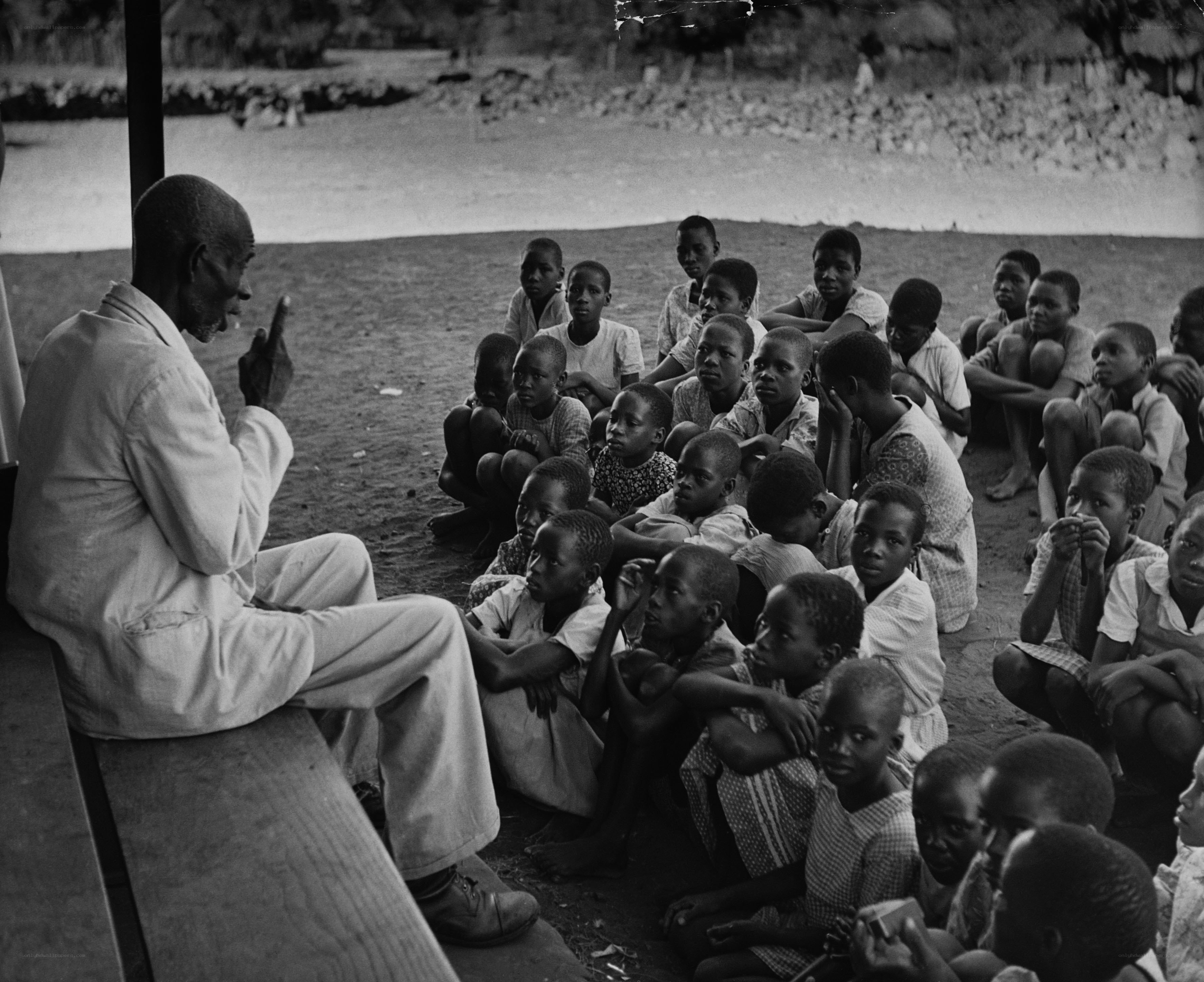 Man teaching children outdoors