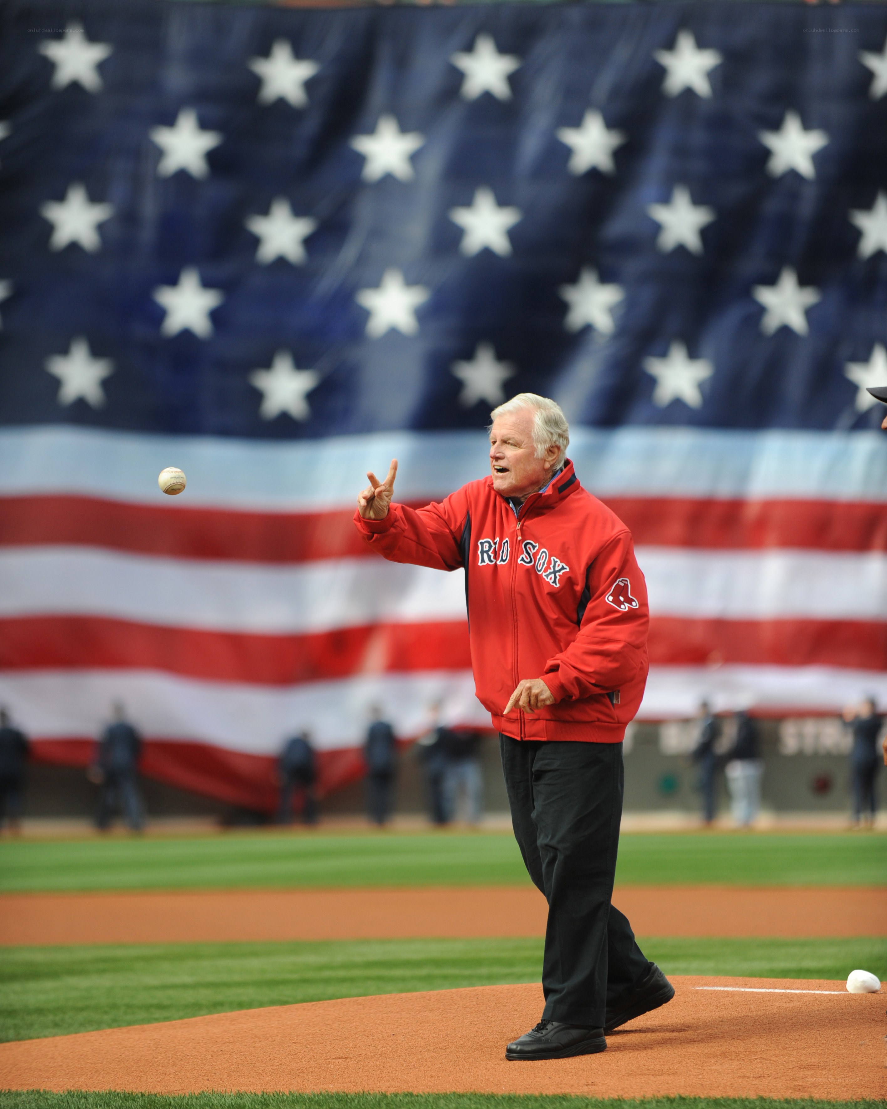 Man throwing first pitch at baseball game