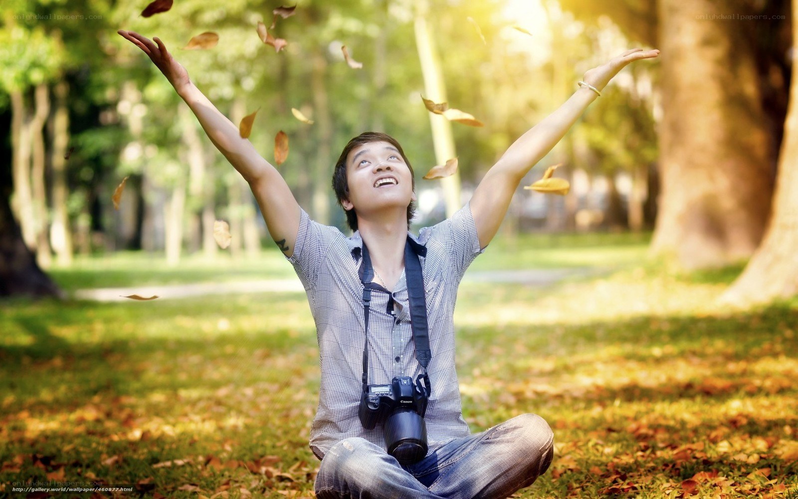 Man throwing leaves in park