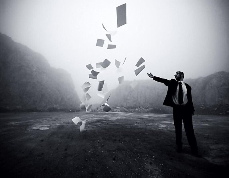 Man throwing papers in fog