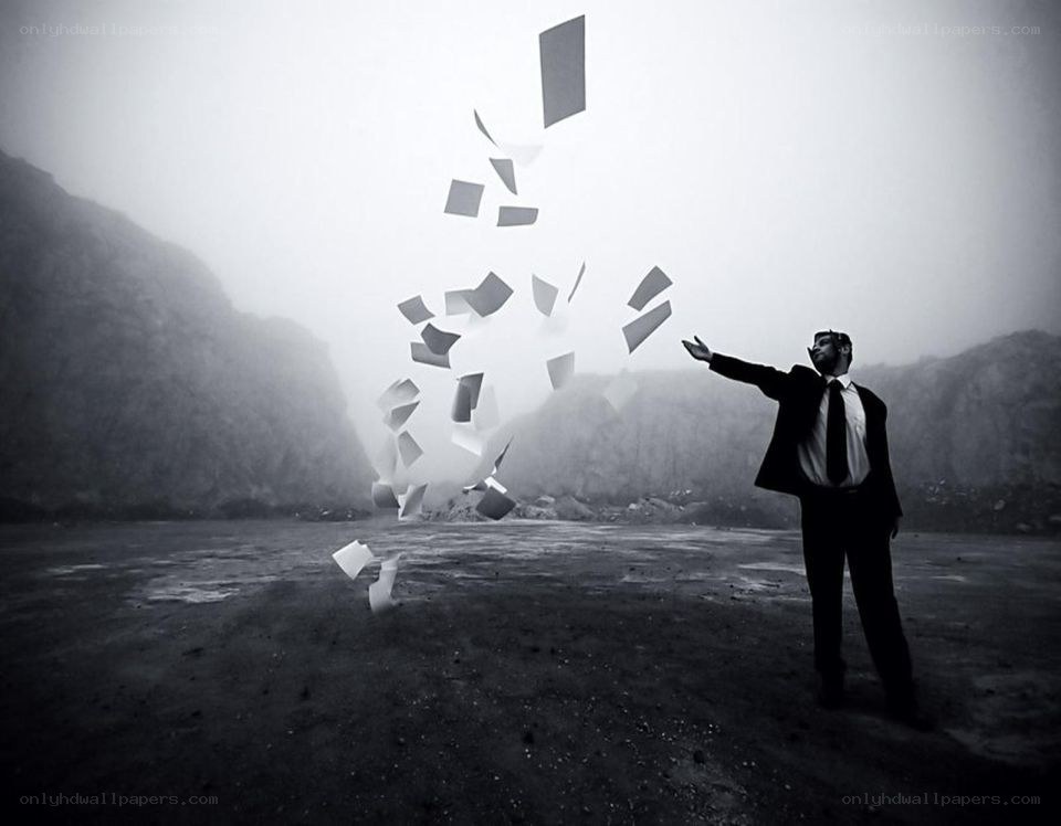 Man throwing papers in fog