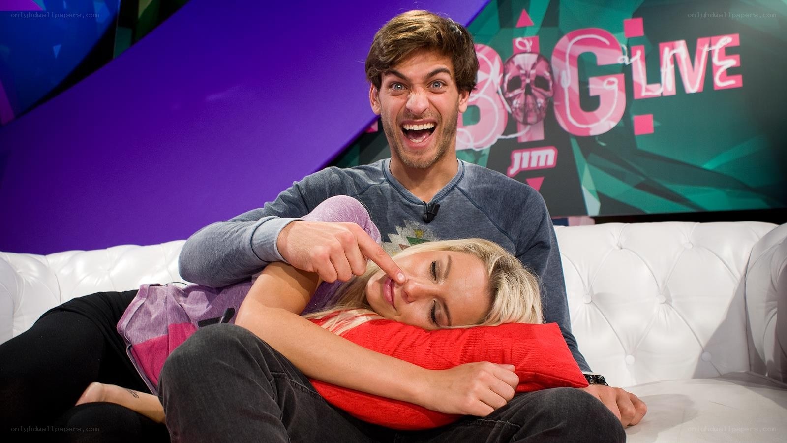 Man tickling woman on couch