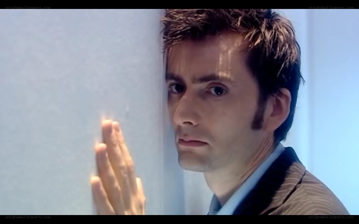 man touching wall with hand