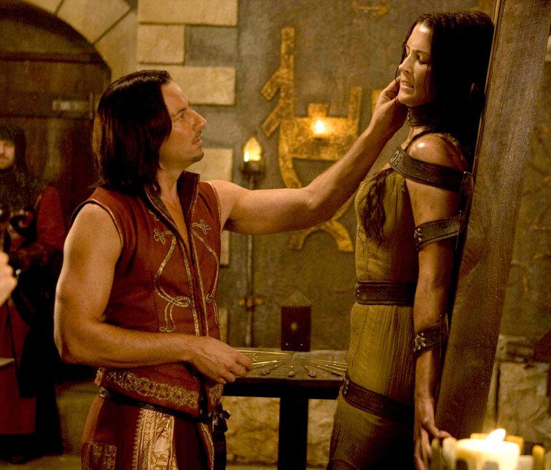 Man touching woman's face in dungeon
