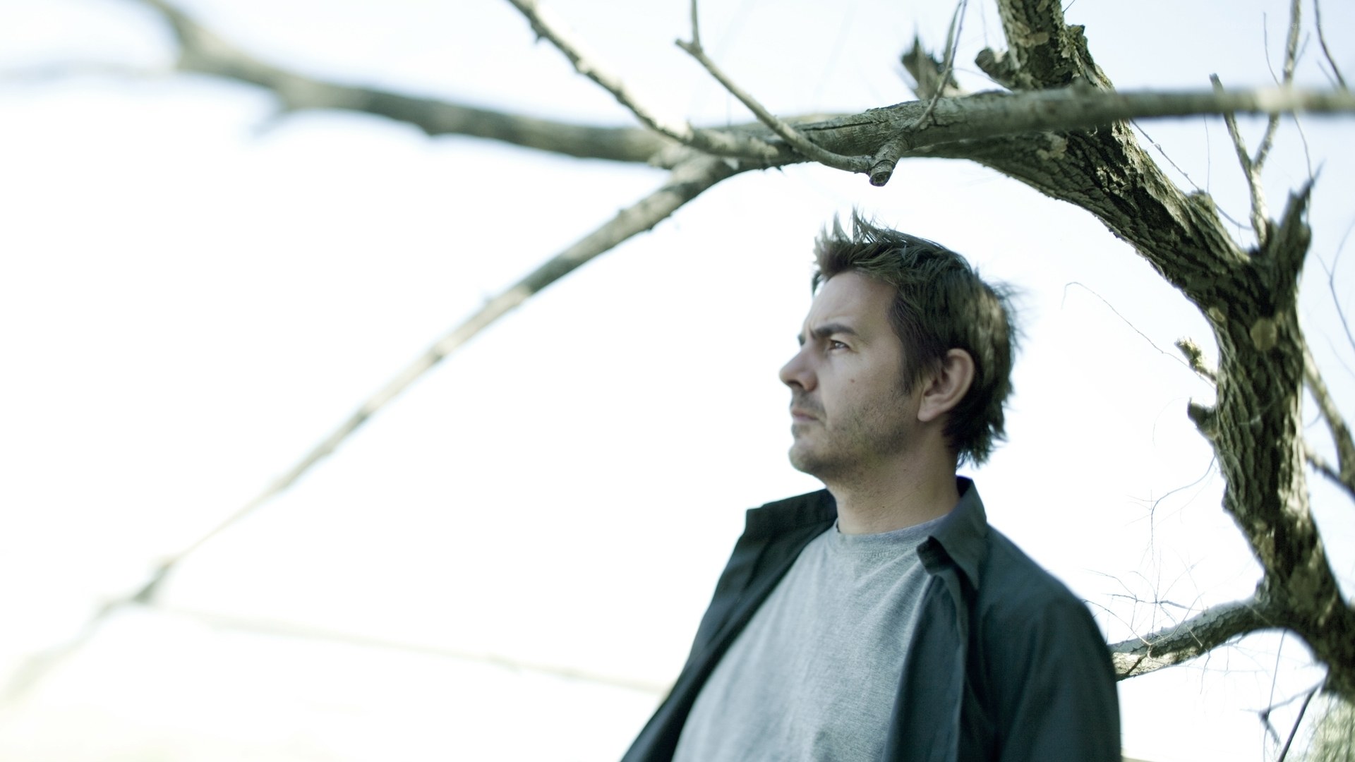 man under bare tree