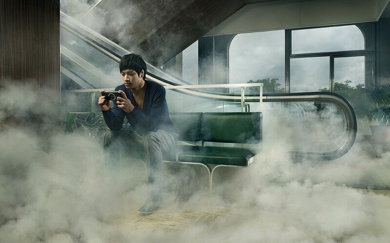 man using camera in smoky station
