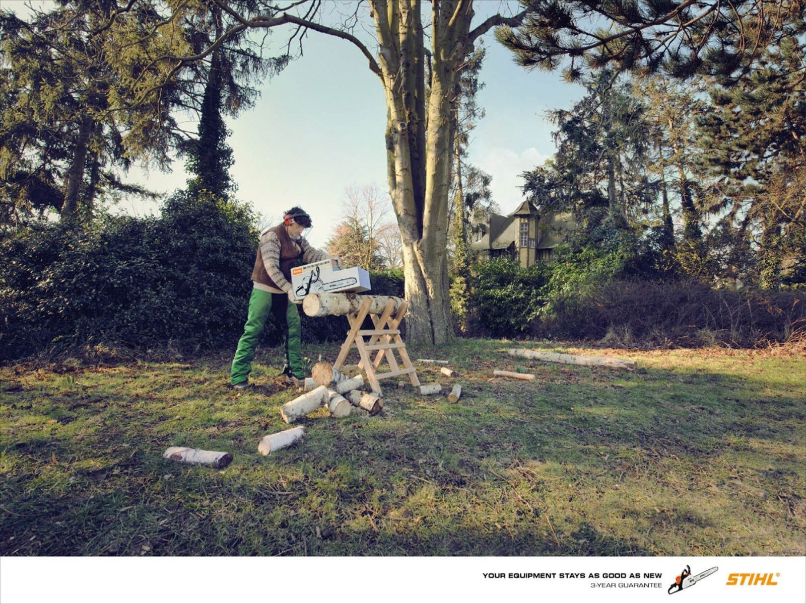 man using chainsaw outdoors