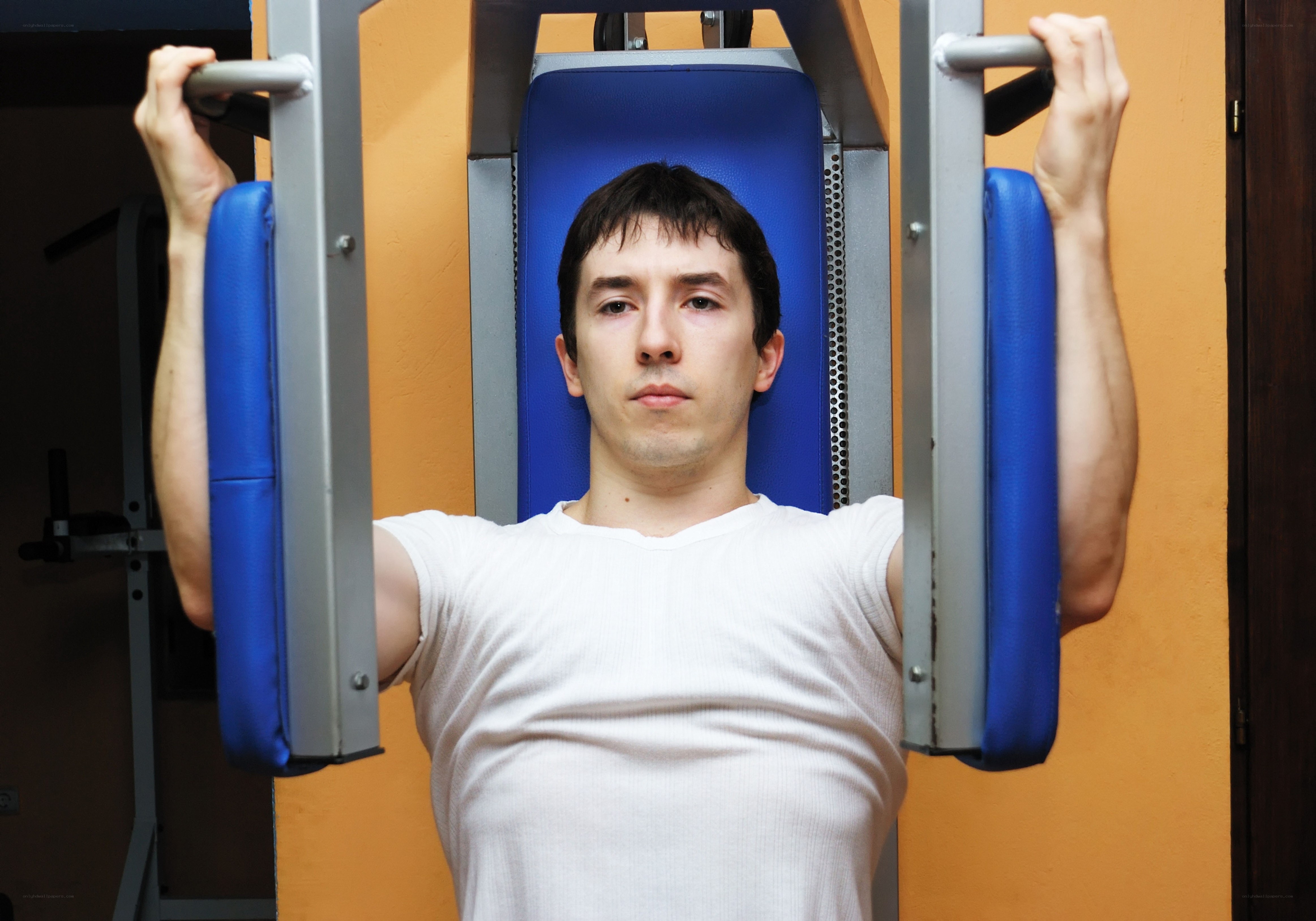 man using chest press machine