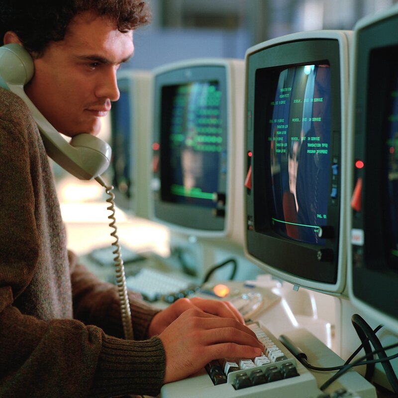 man using computer and phone