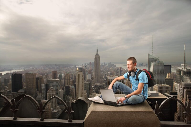 Man Using Laptop on Rooftop