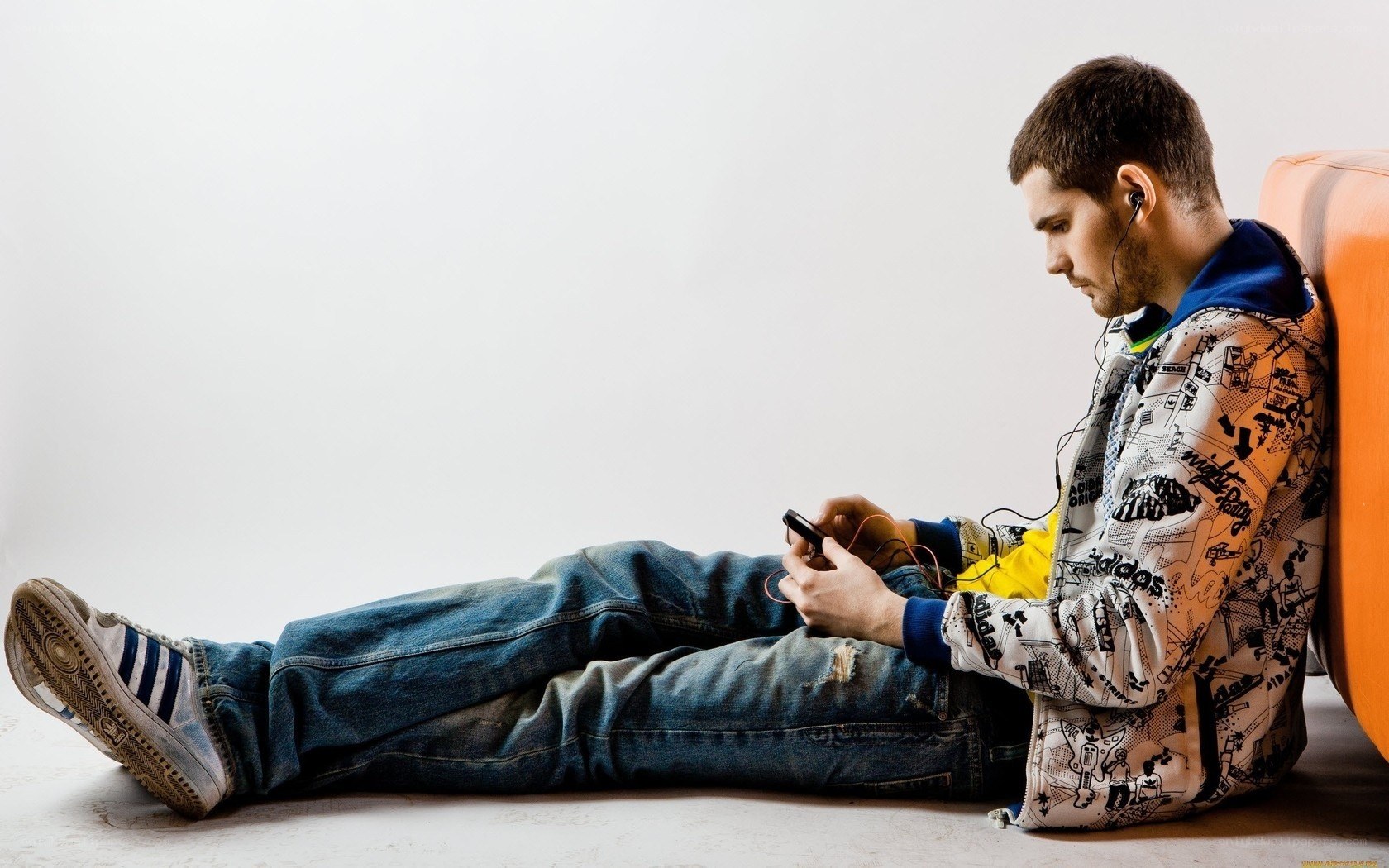 man using smartphone on floor