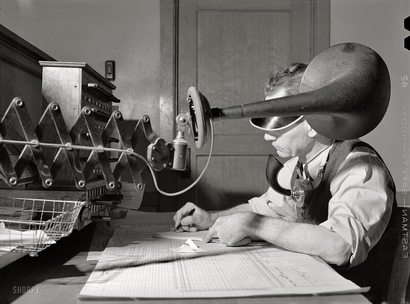Man using vintage telephone equipment