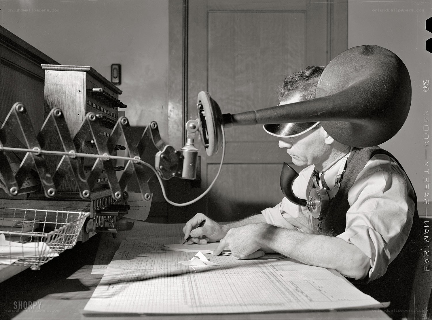 Man using vintage telephone equipment