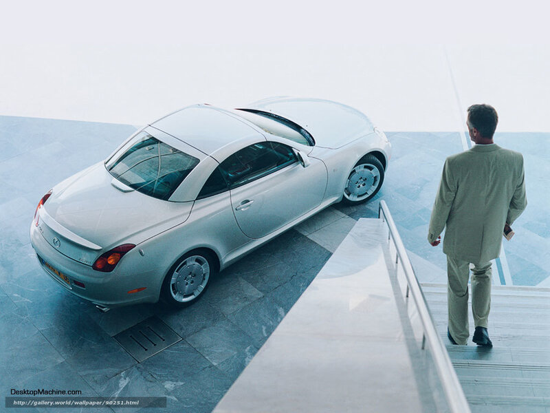 Man viewing silver sports car