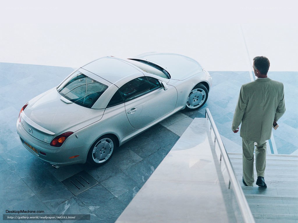 Man viewing silver sports car