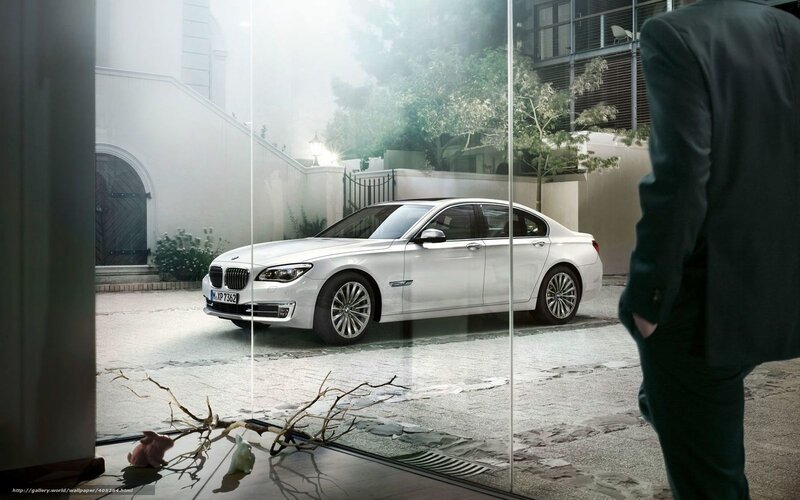 Man viewing white BMW sedan