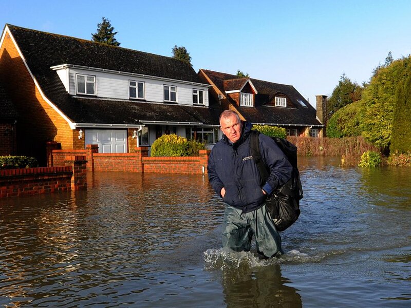 Man Wading Through Flood
