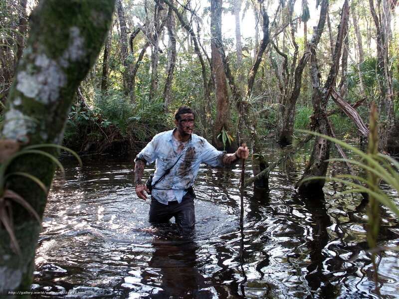Man wading through swamp