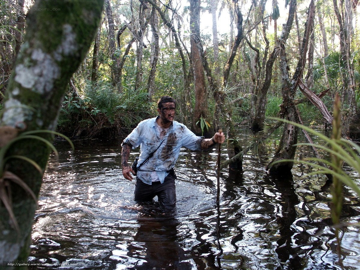 Man wading through swamp