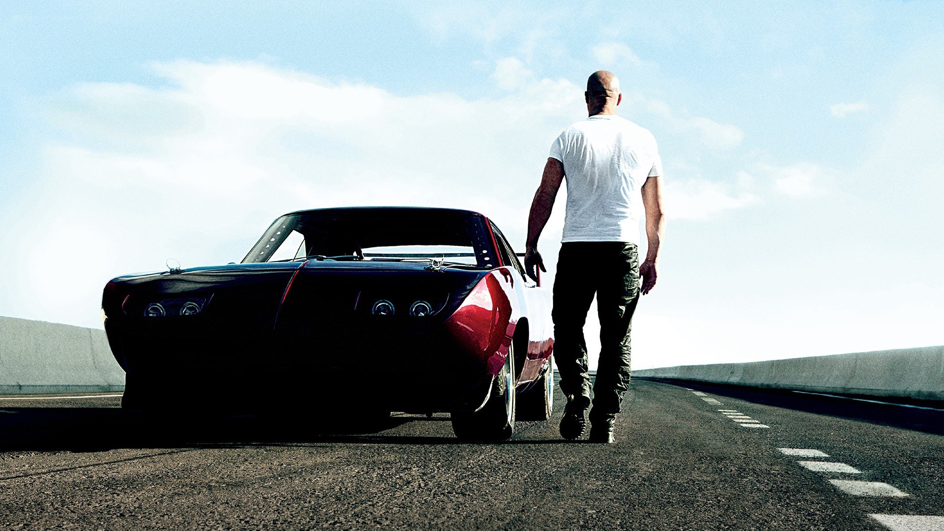 man walking beside a classic car