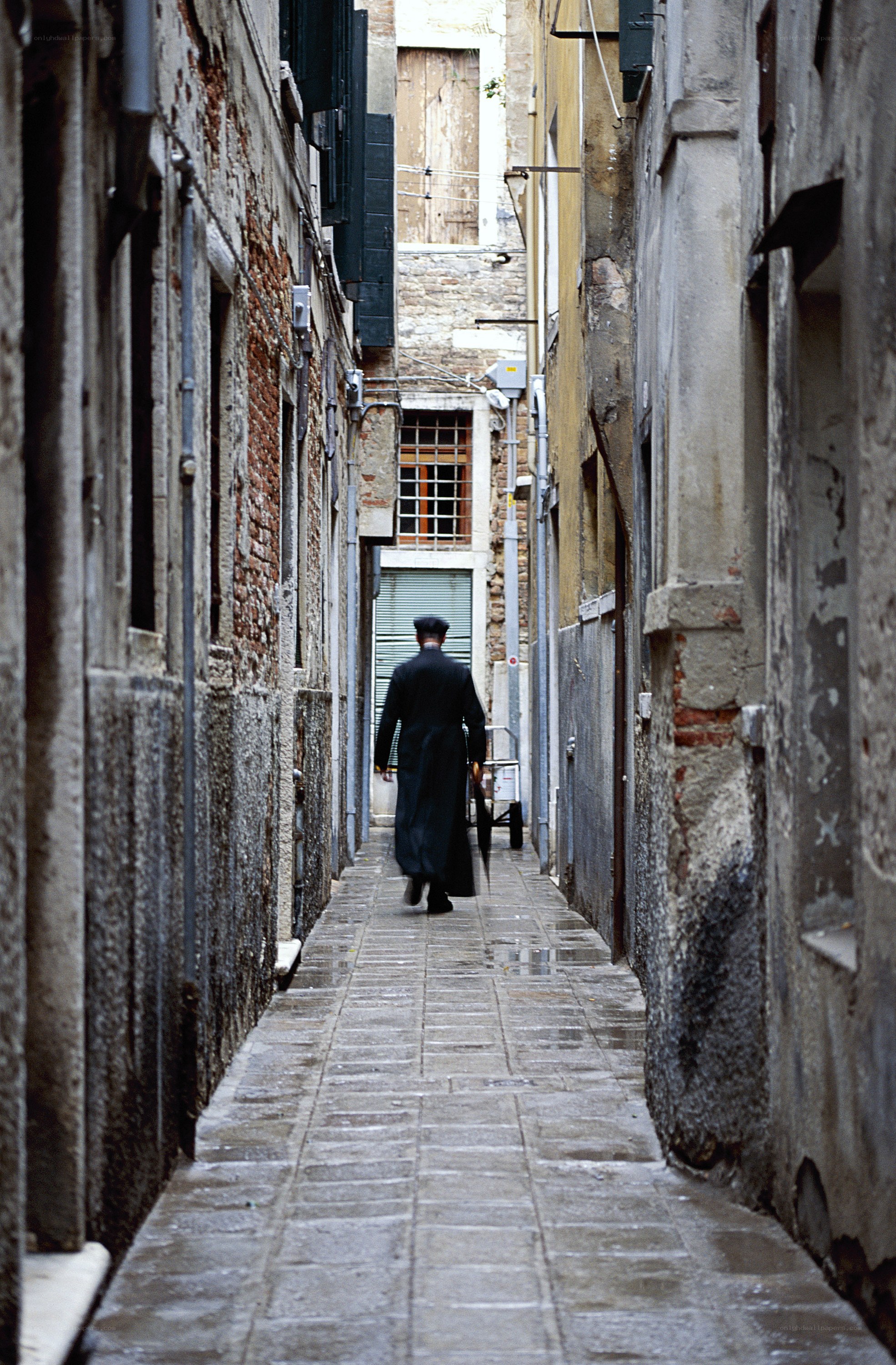Man walking down a narrow alley