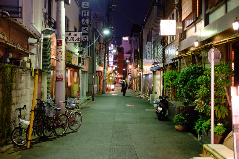 Man Walking Down Alley