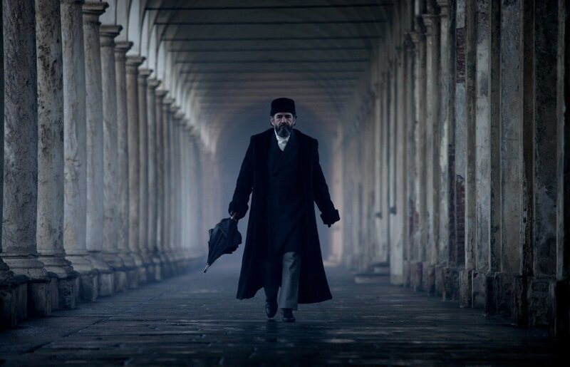 man walking in a colonnade