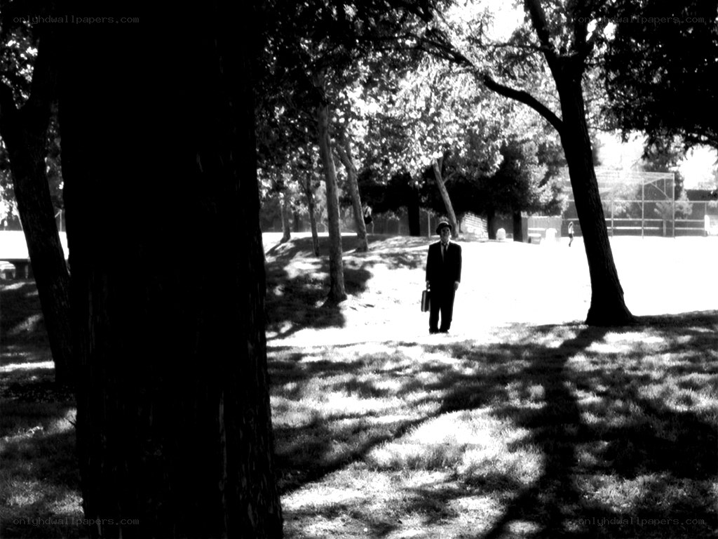 Man walking in park with briefcase
