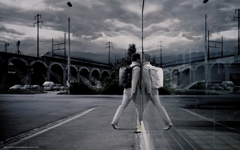 Man walking near train bridge