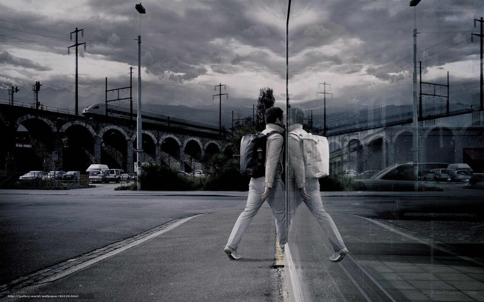 Man walking near train bridge