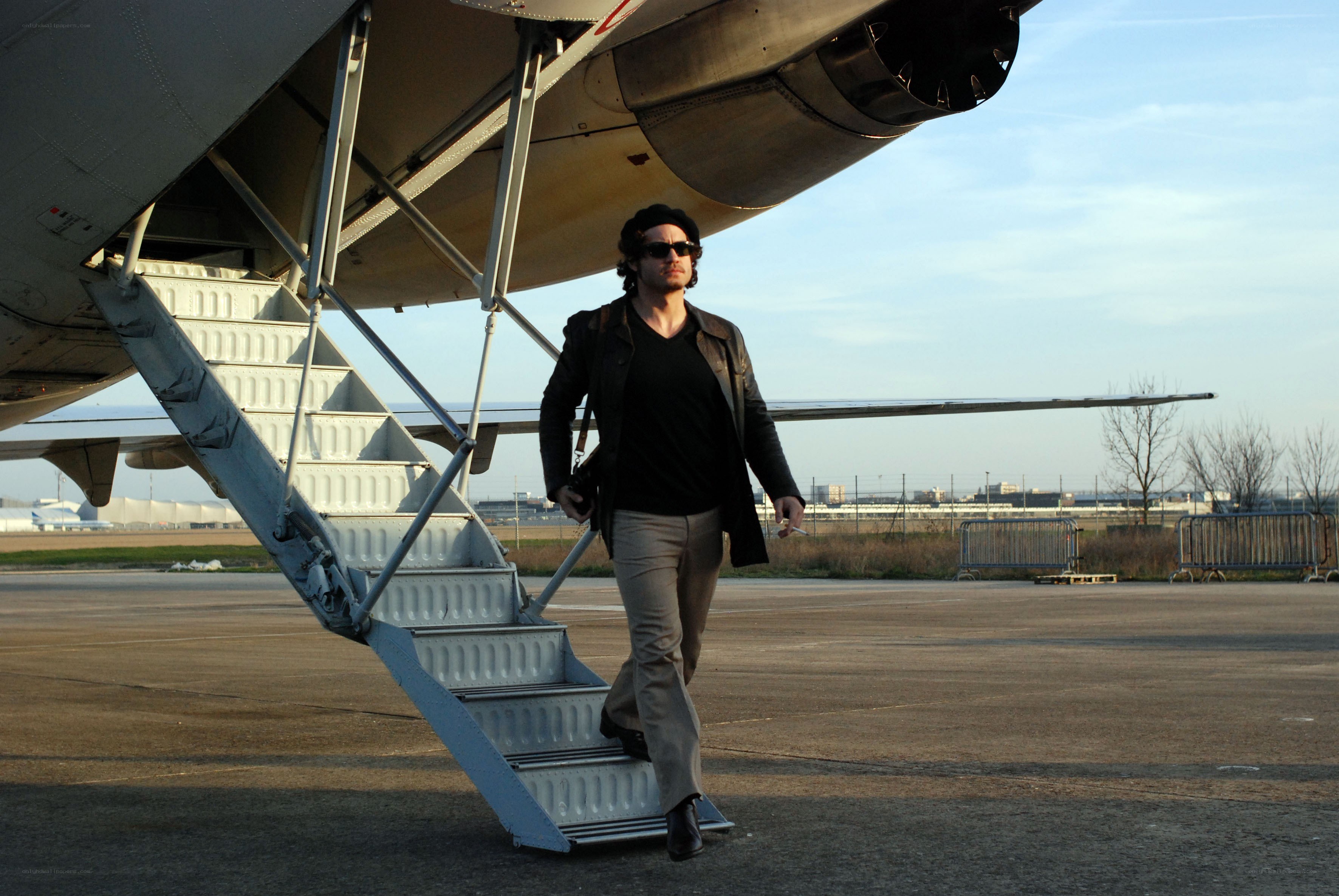 man walking off airplane stairs