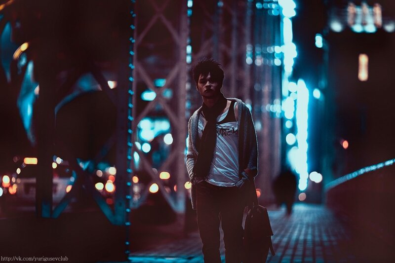 man walking on bridge at night