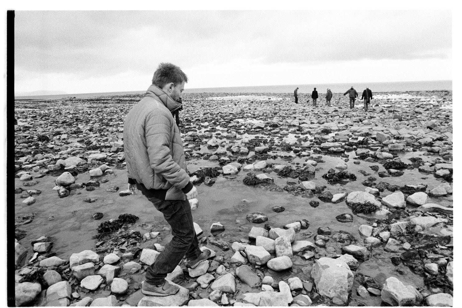 Man walking on rocky beach
