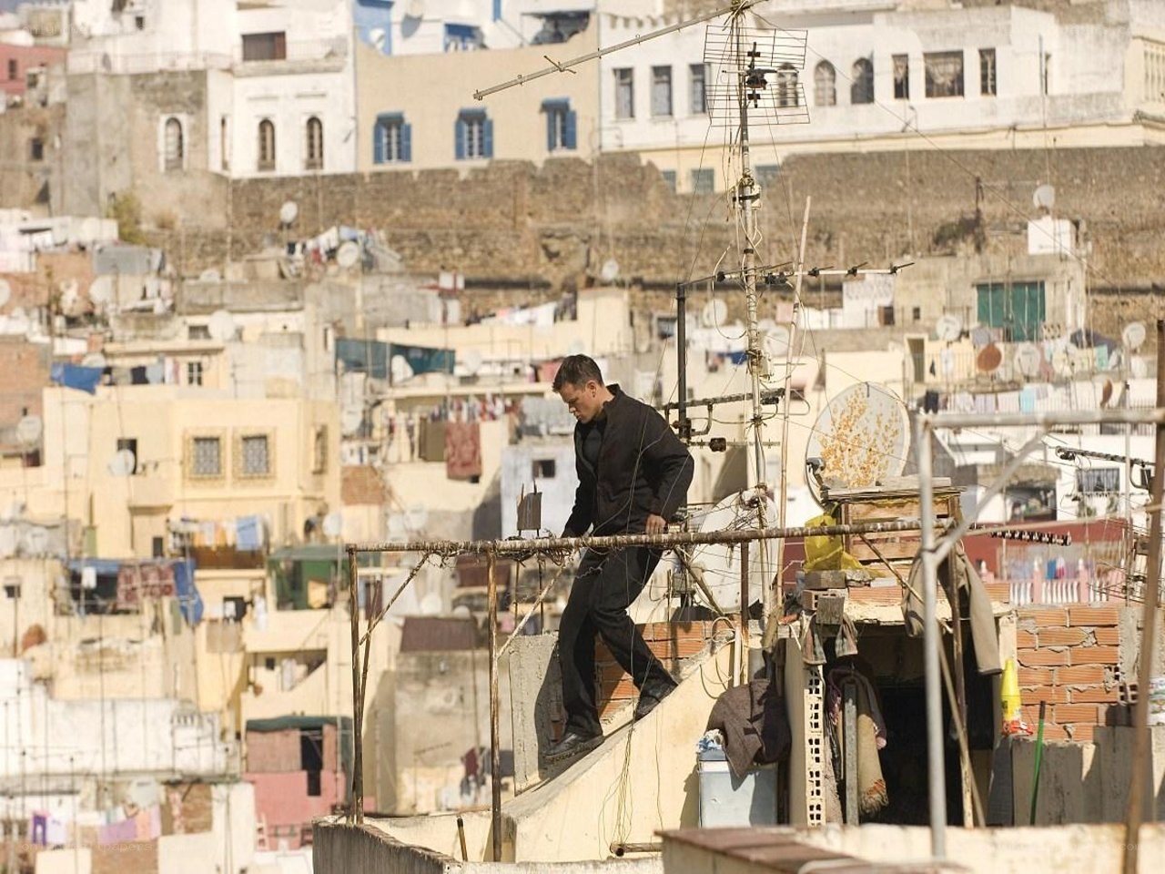 Man walking on rooftop in city