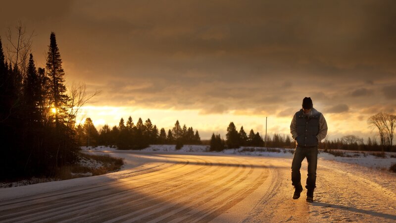 Man Walking on Snowy Road