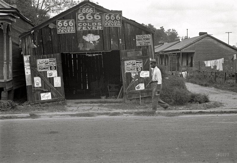 Man walking past a medicine shed