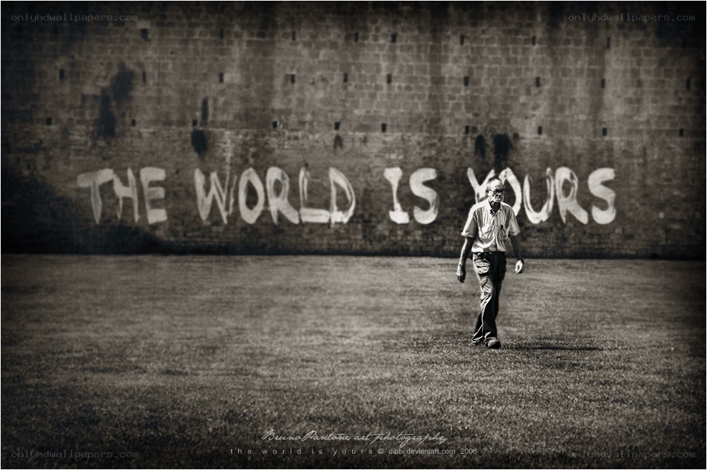 man walking past graffiti