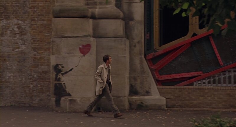 Man Walking Past Mural — Gray, Somber