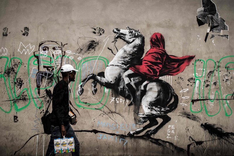 Man Walking Past Mural — Gray