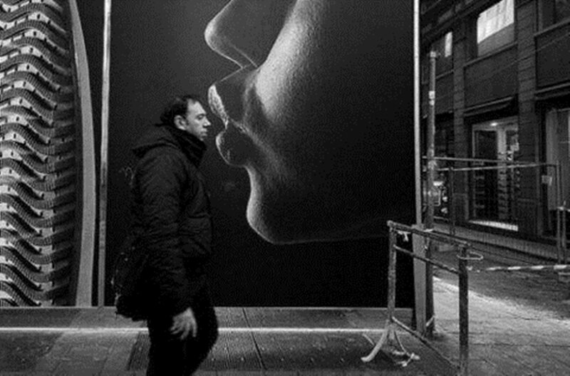 Man Walking Past Mural
