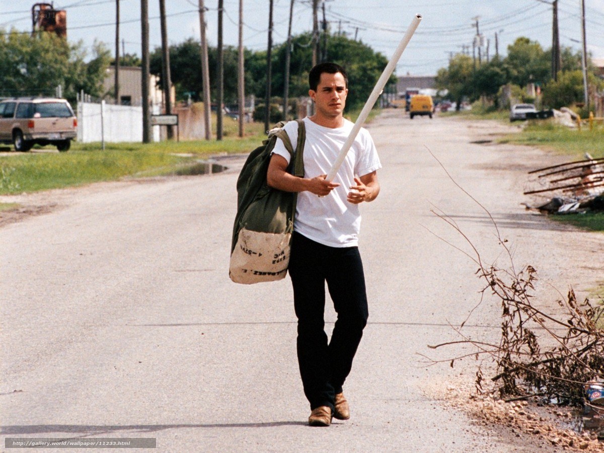 Man walking with bag and pole