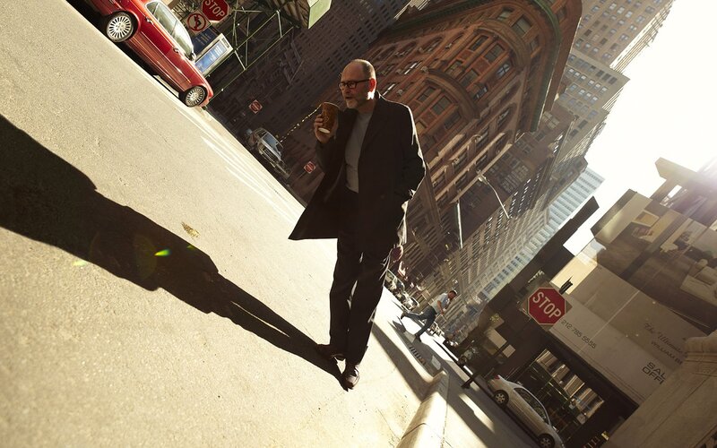 Man walking with coffee in city