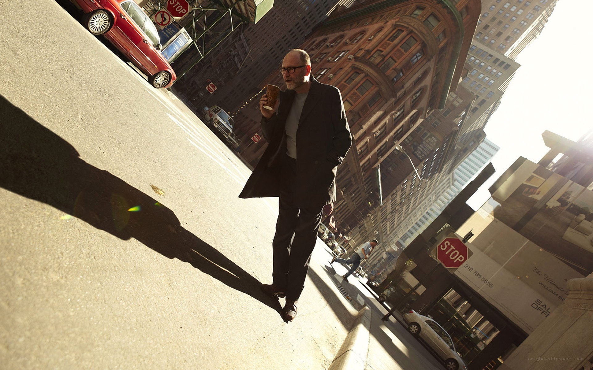 Man walking with coffee in city