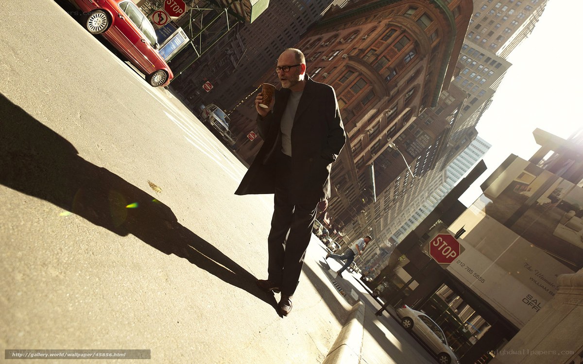 Man walking with coffee in city