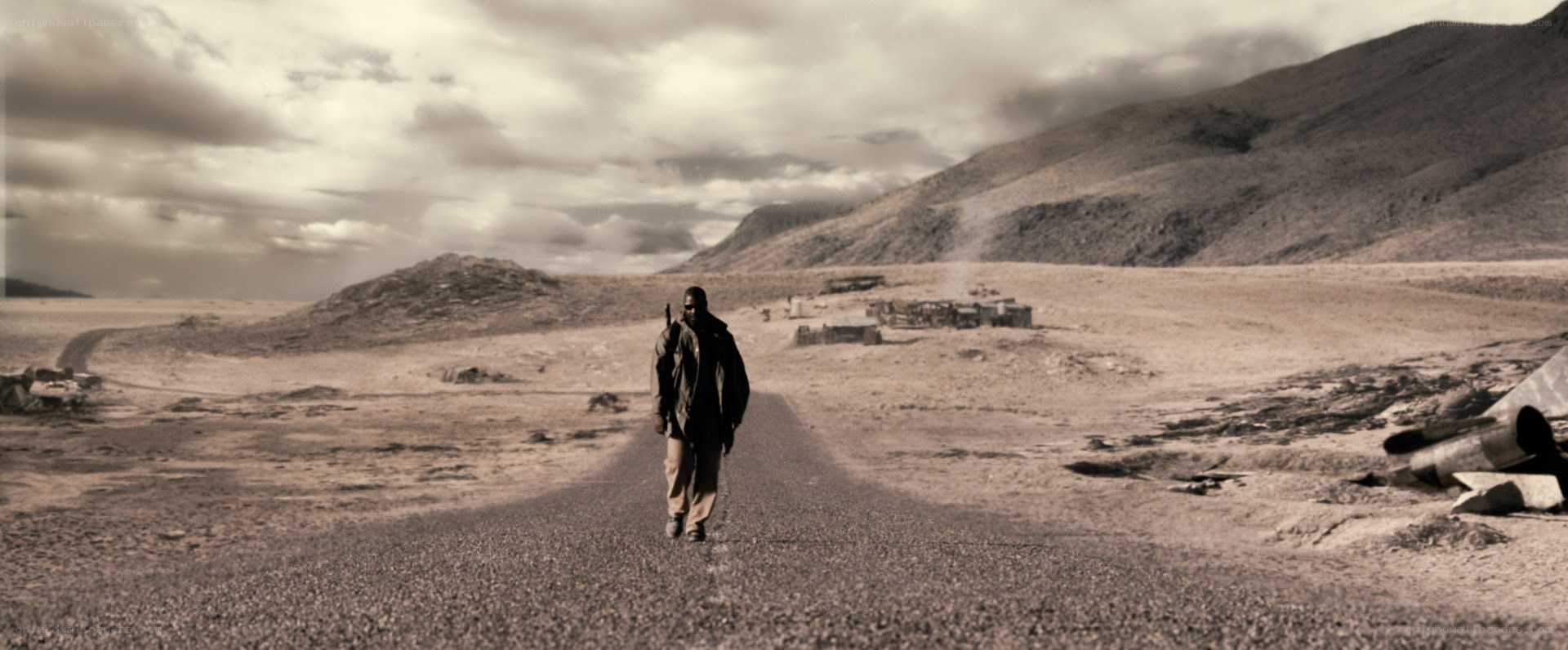 man walks on desert road