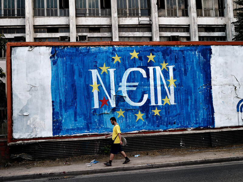 Man walks past EU graffiti