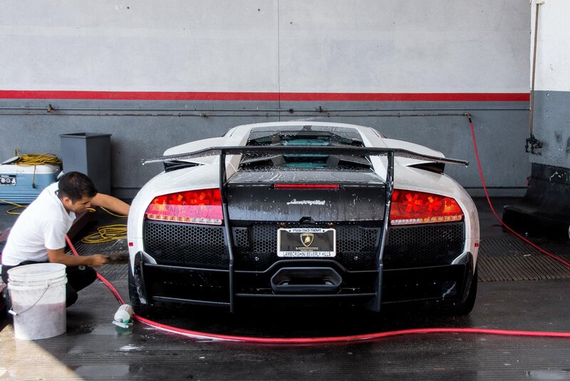 Man washing a Lamborghini