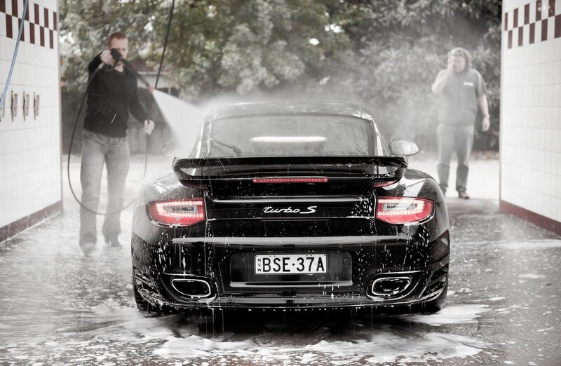 Man washing black Porsche Turbo S