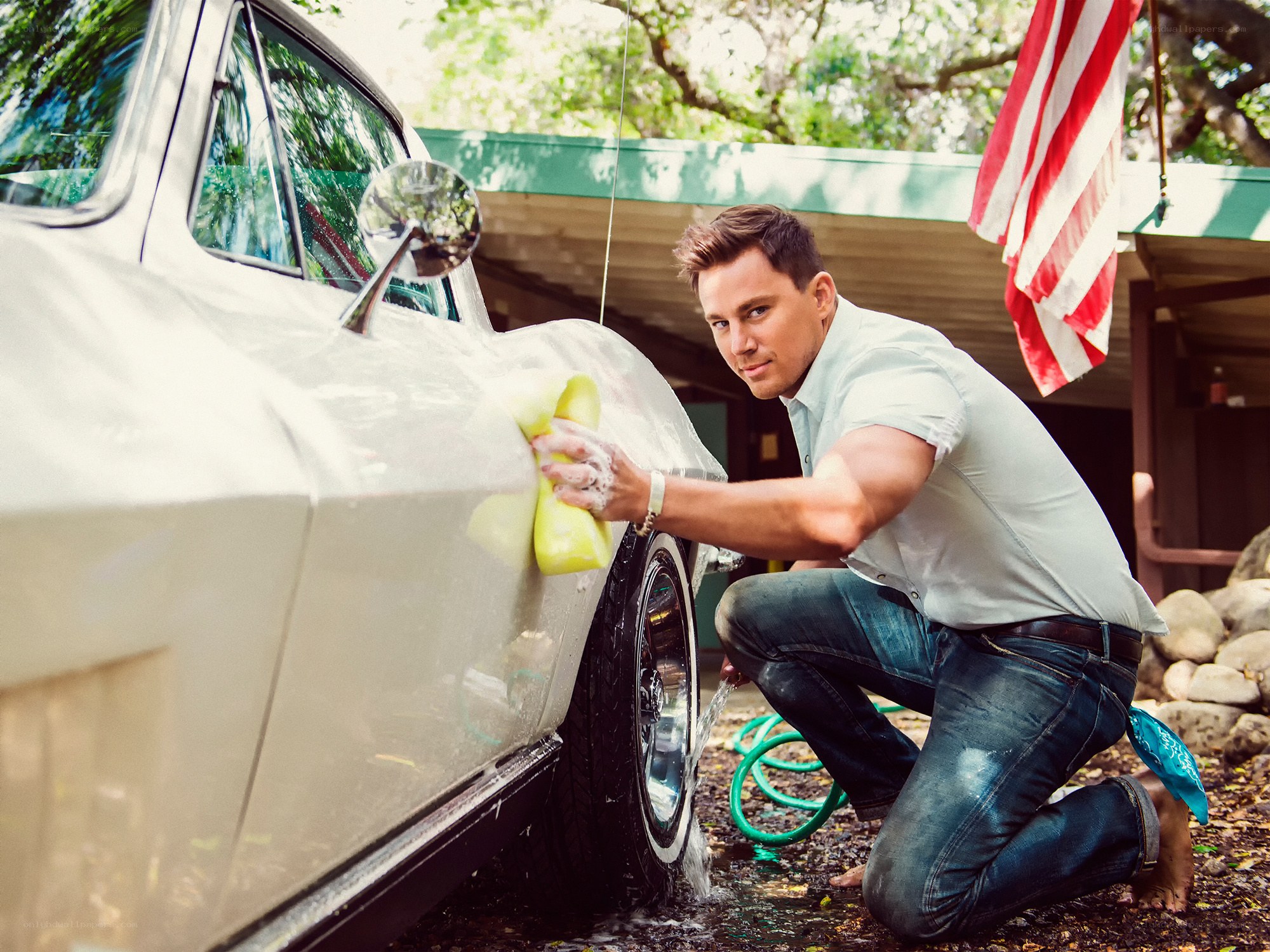man washing classic car